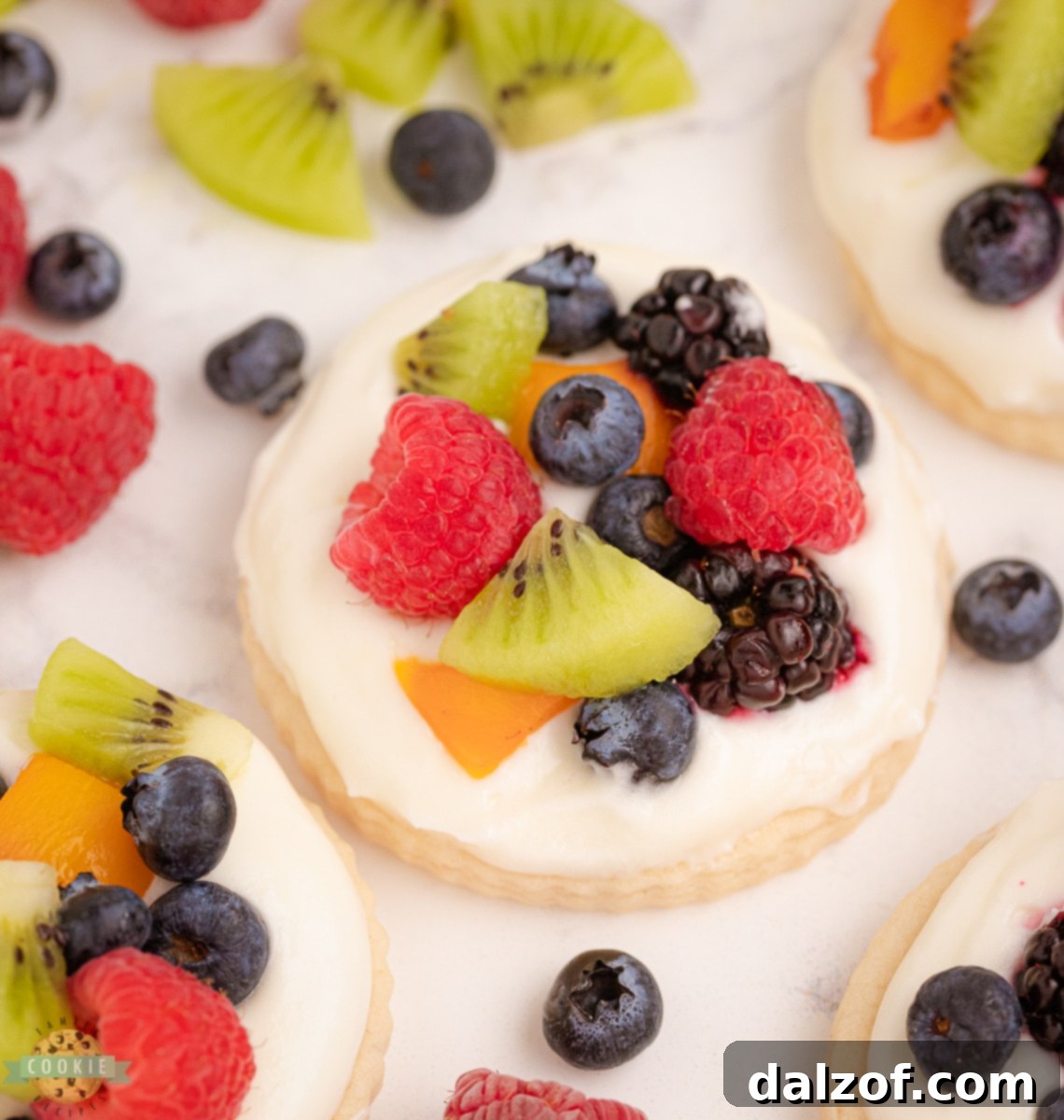 Variety of fruit pizza cookies adorned with a mix of fresh berries