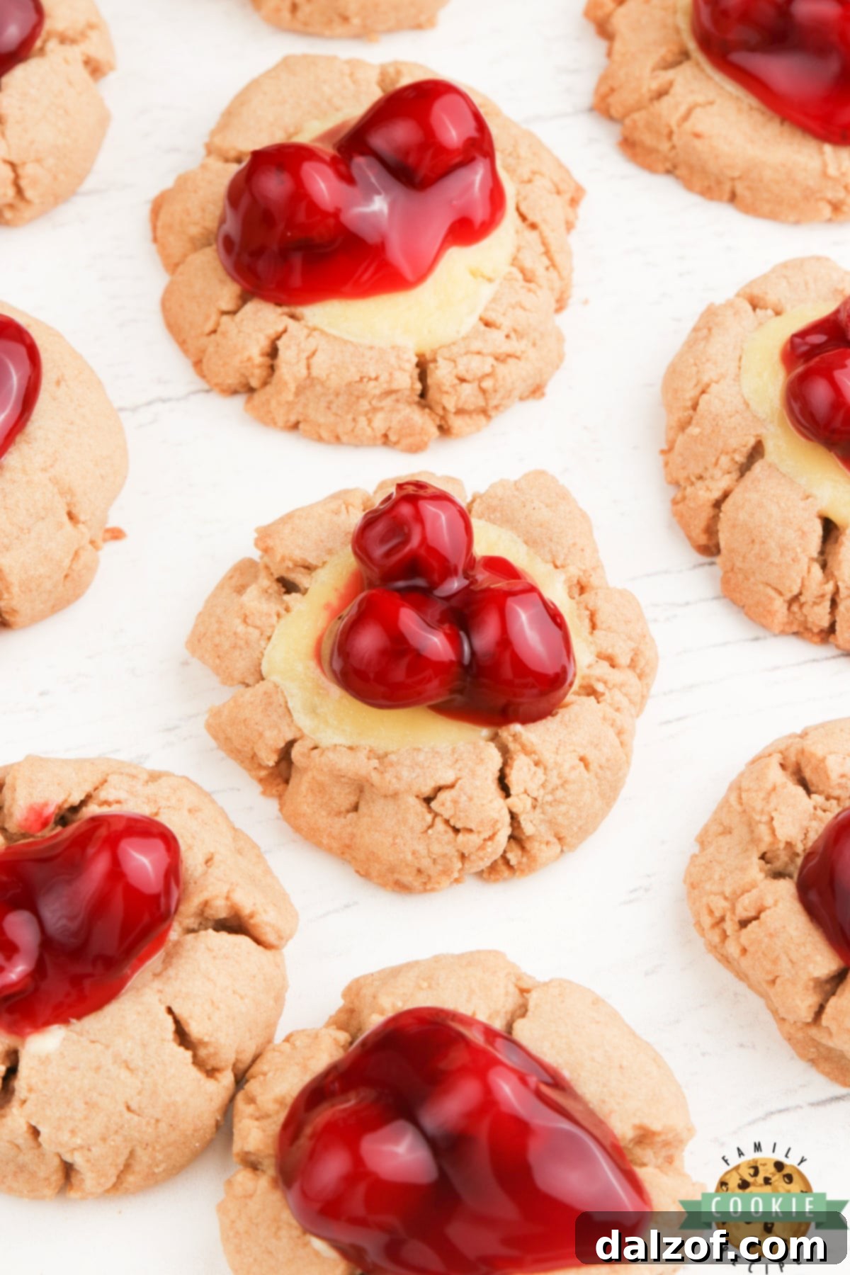 Graham cracker cookies with a cheesecake filling and cherries on top