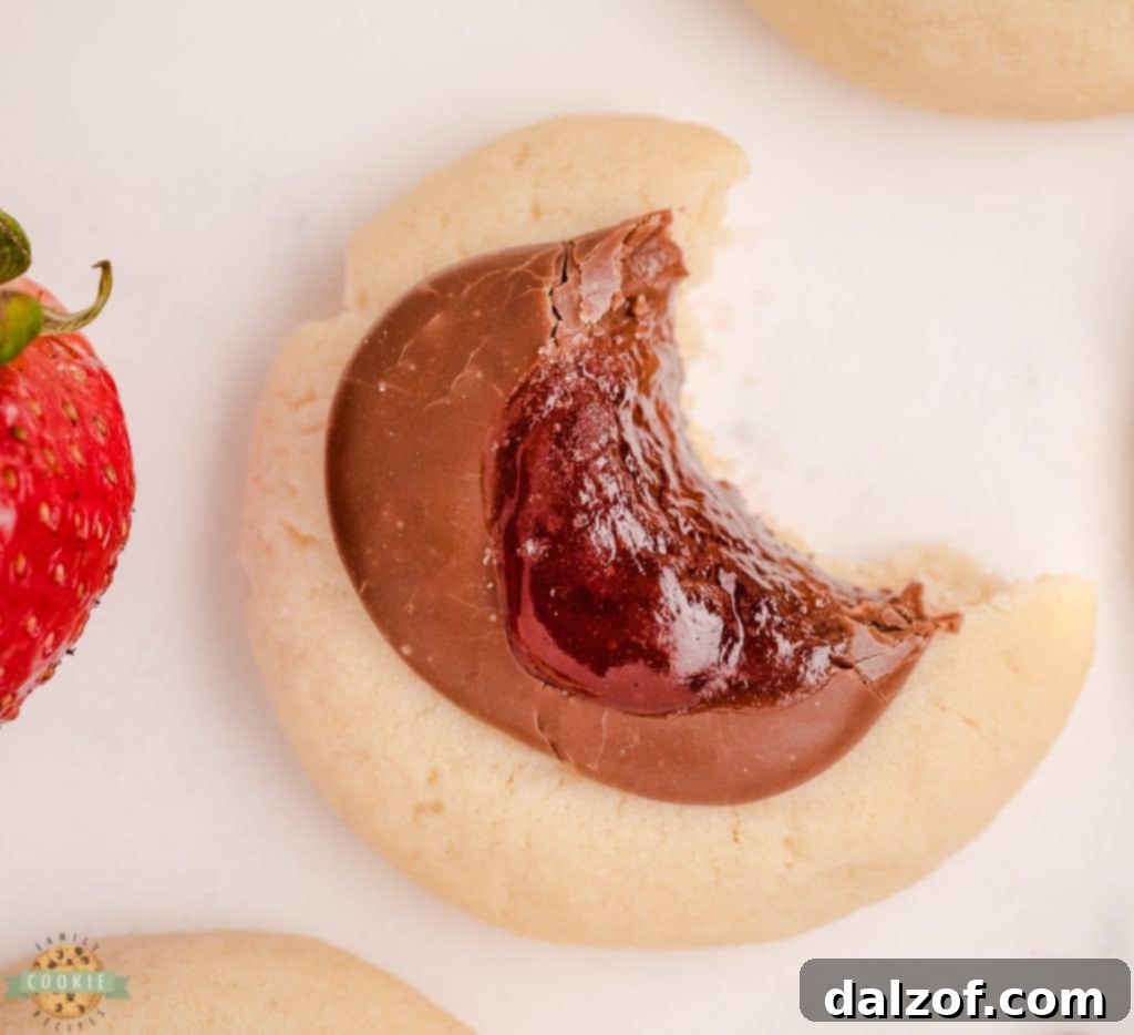 bite of a chocolate strawberry jam cookie