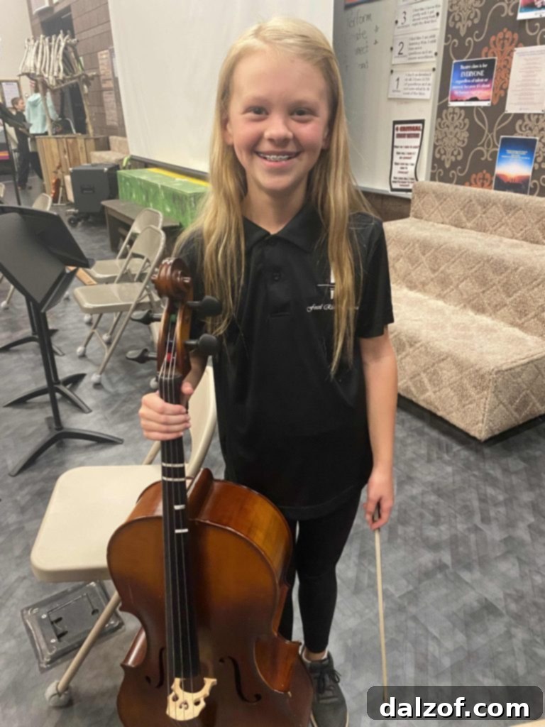 A child playing the cello, showcasing a passion for music.