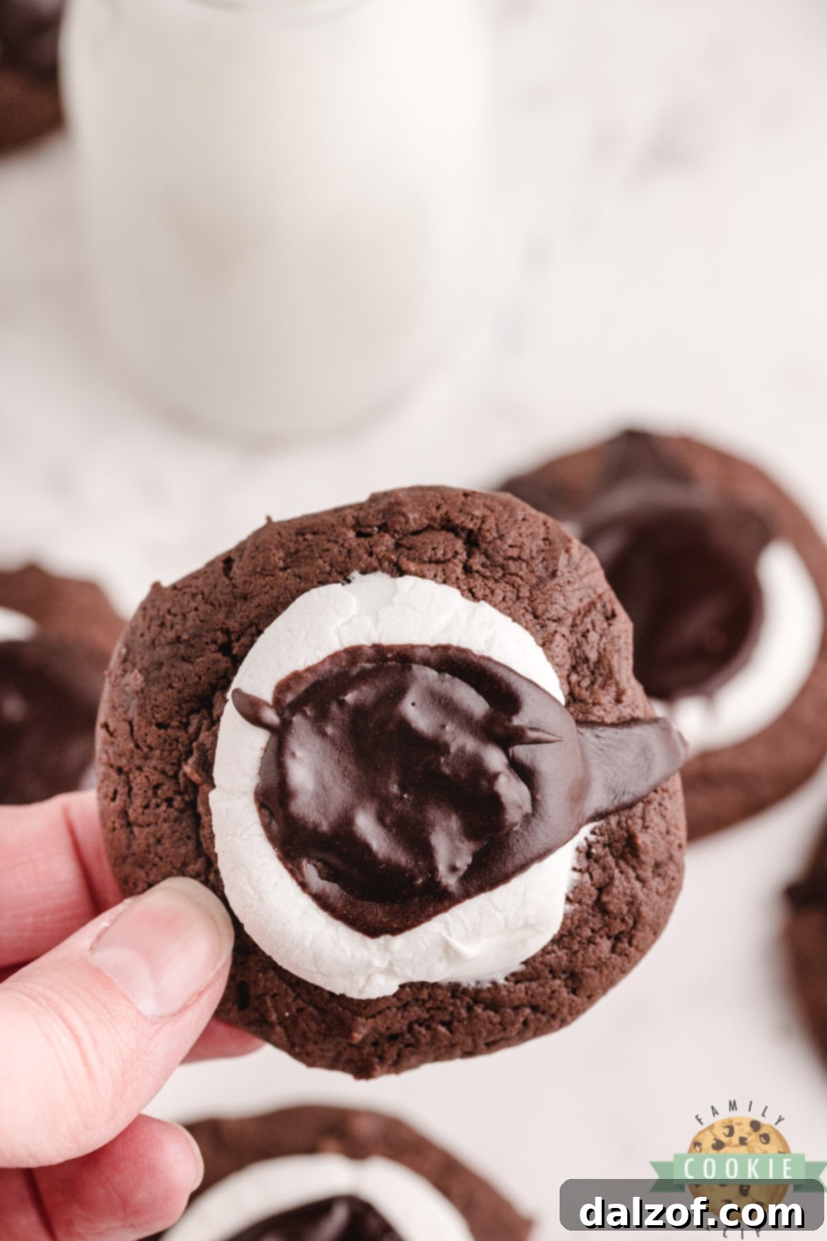 A single homemade chocolate cookie with marshmallow and fudge frosting, ready to eat