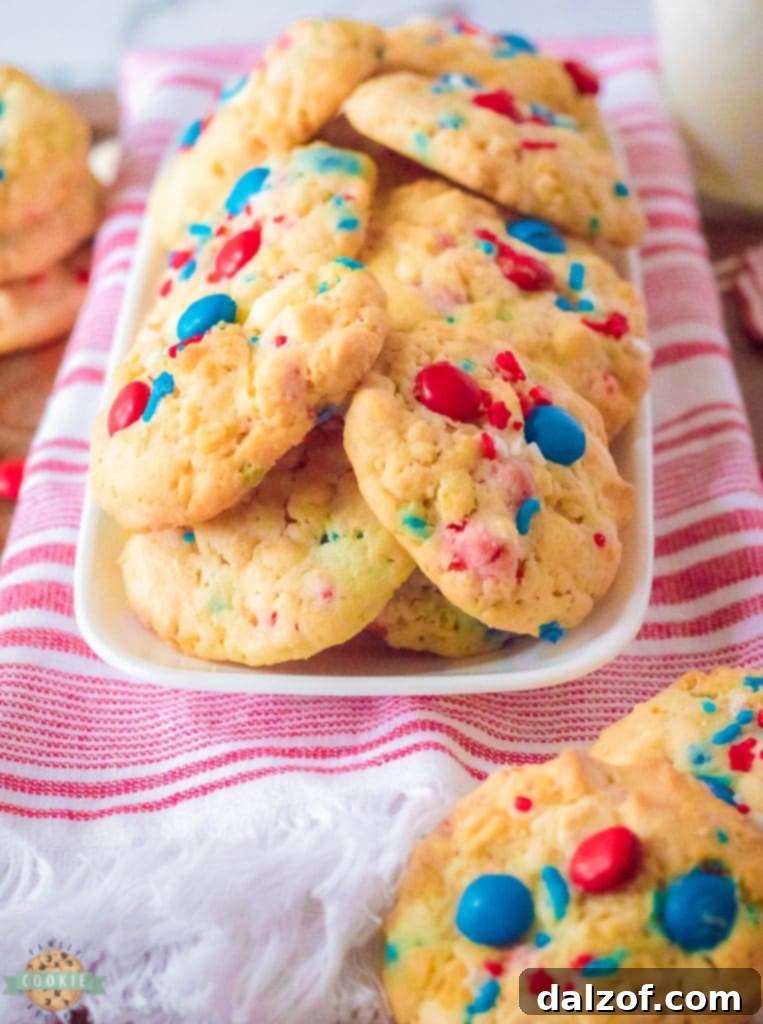 A perfectly round baked Krispy M&M 4th of July cookie on a cooling rack.