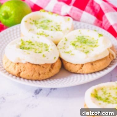 Three perfectly crafted key lime pie cookies on a plate, ready to be enjoyed.