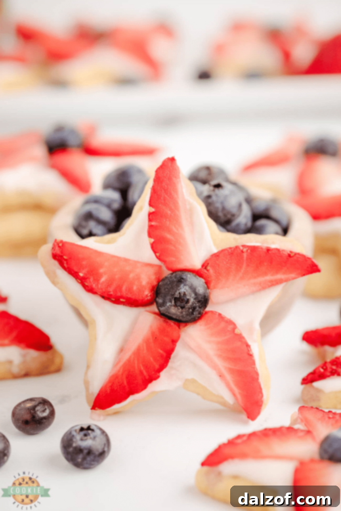 Festive star-shaped cookies decorated with red, white, and blue berries.