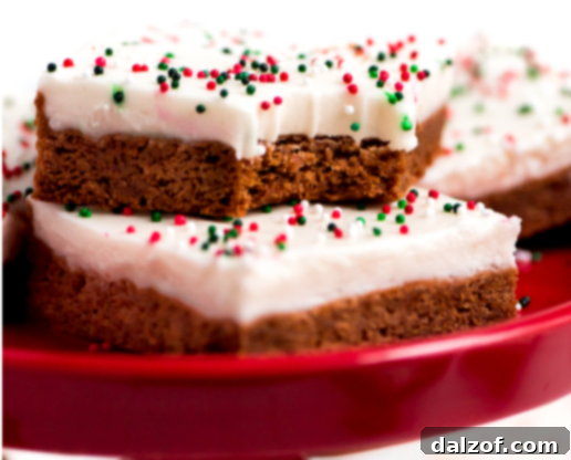 Gingerbread Sugar Cookie Bars topped with cream cheese frosting.