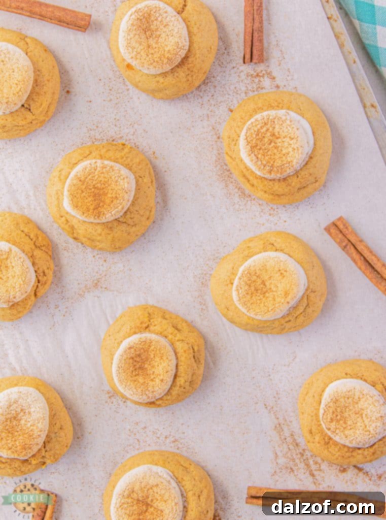 Unbaked sweet potato cookie dough balls on parchment paper, ready for the oven.