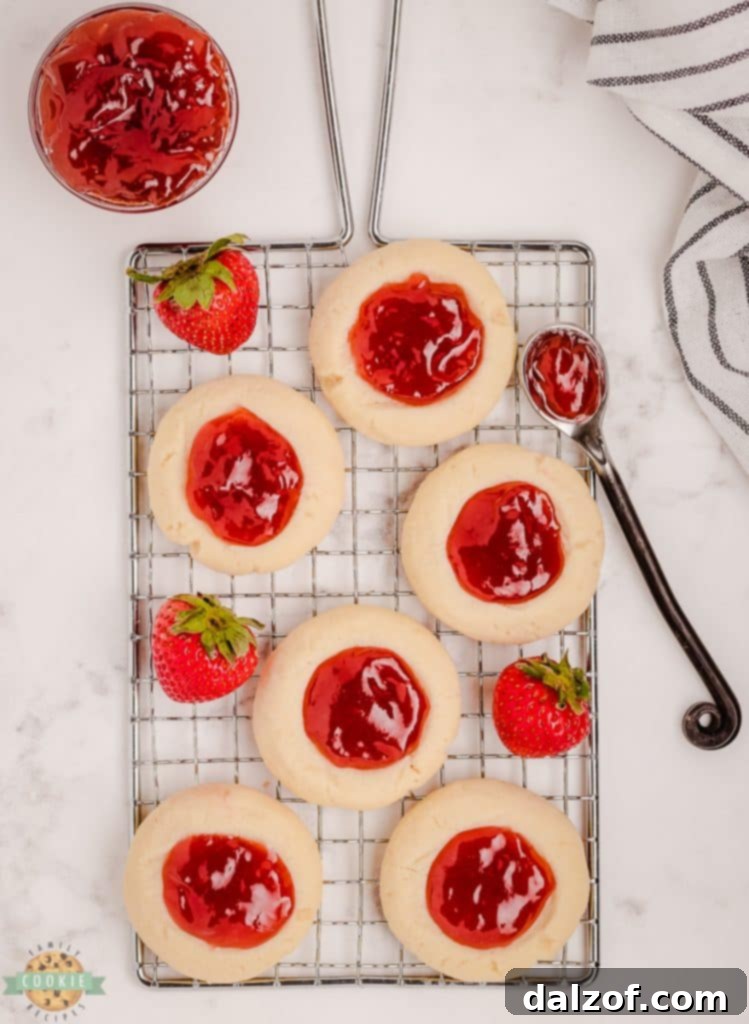 strawberry thumbprint cookies on a cooling rack