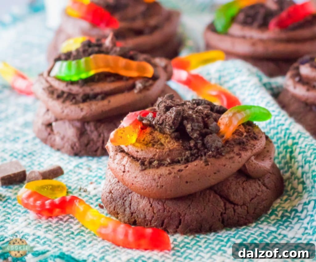 Homemade Crumbl Dirt Cake Cookies with chocolate frosting and gummy worms