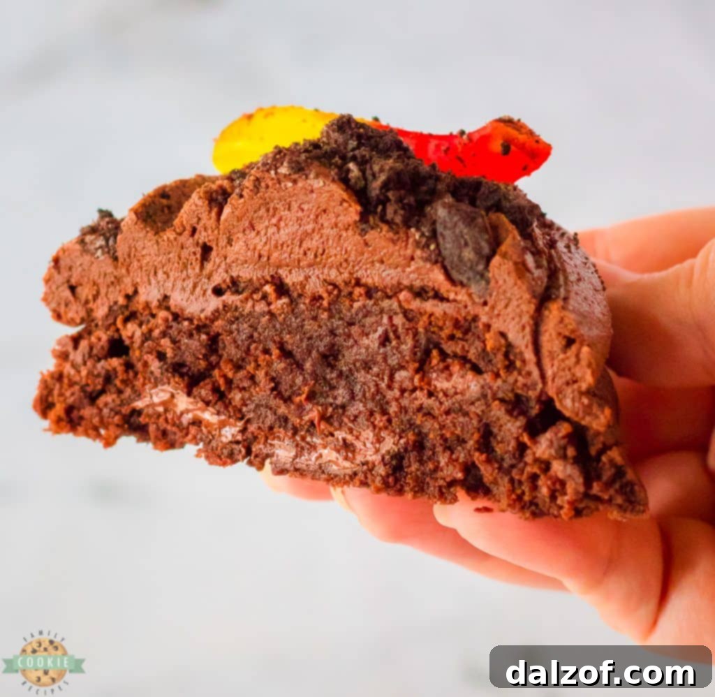 Halved dirt cake cookies showing fudgy chocolate base