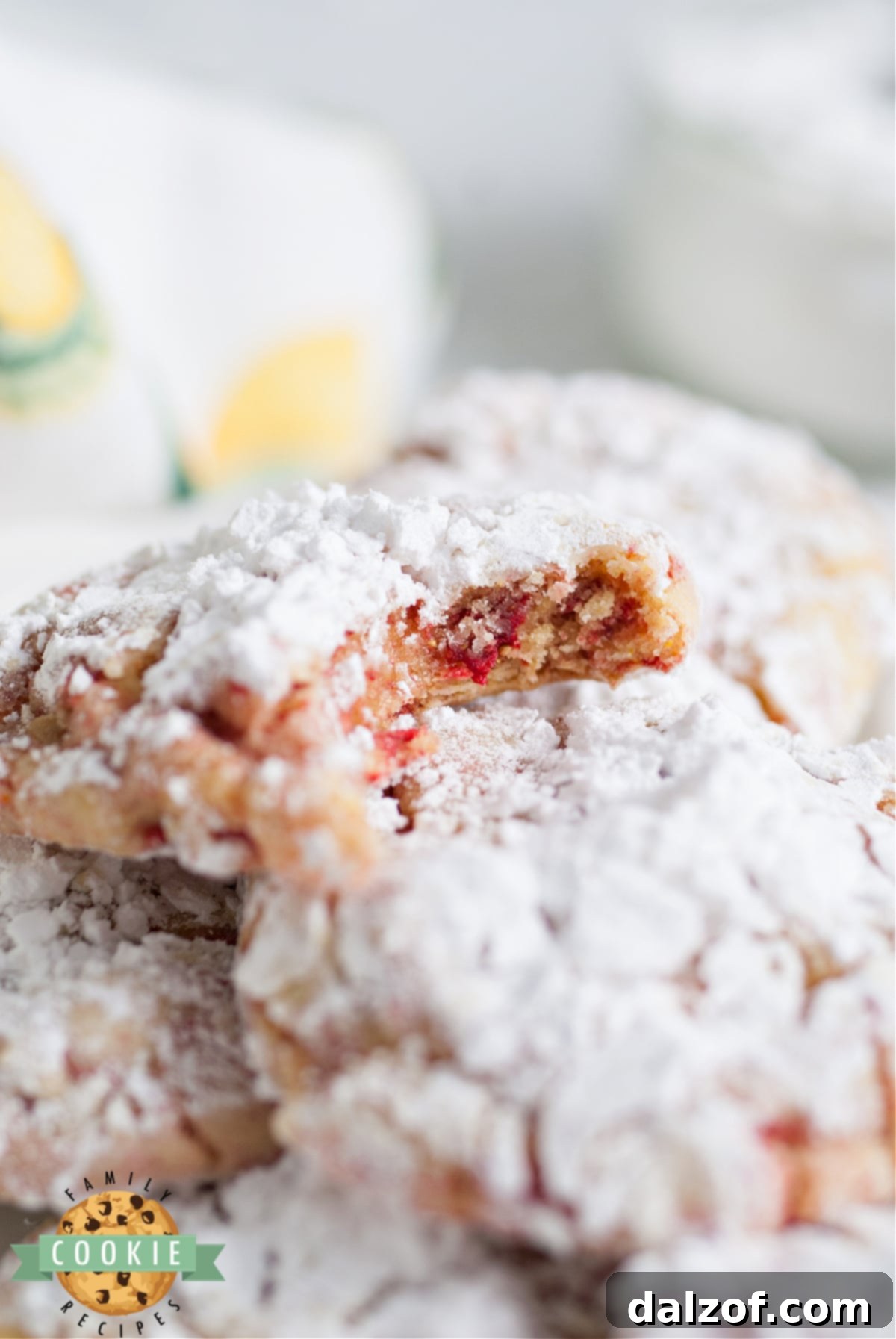 Close-up of freshly baked Strawberry Lemonade Cake Mix Crinkle Cookies, showcasing their soft texture and powdered sugar coating, made with lemon cake mix and freeze dried strawberries.