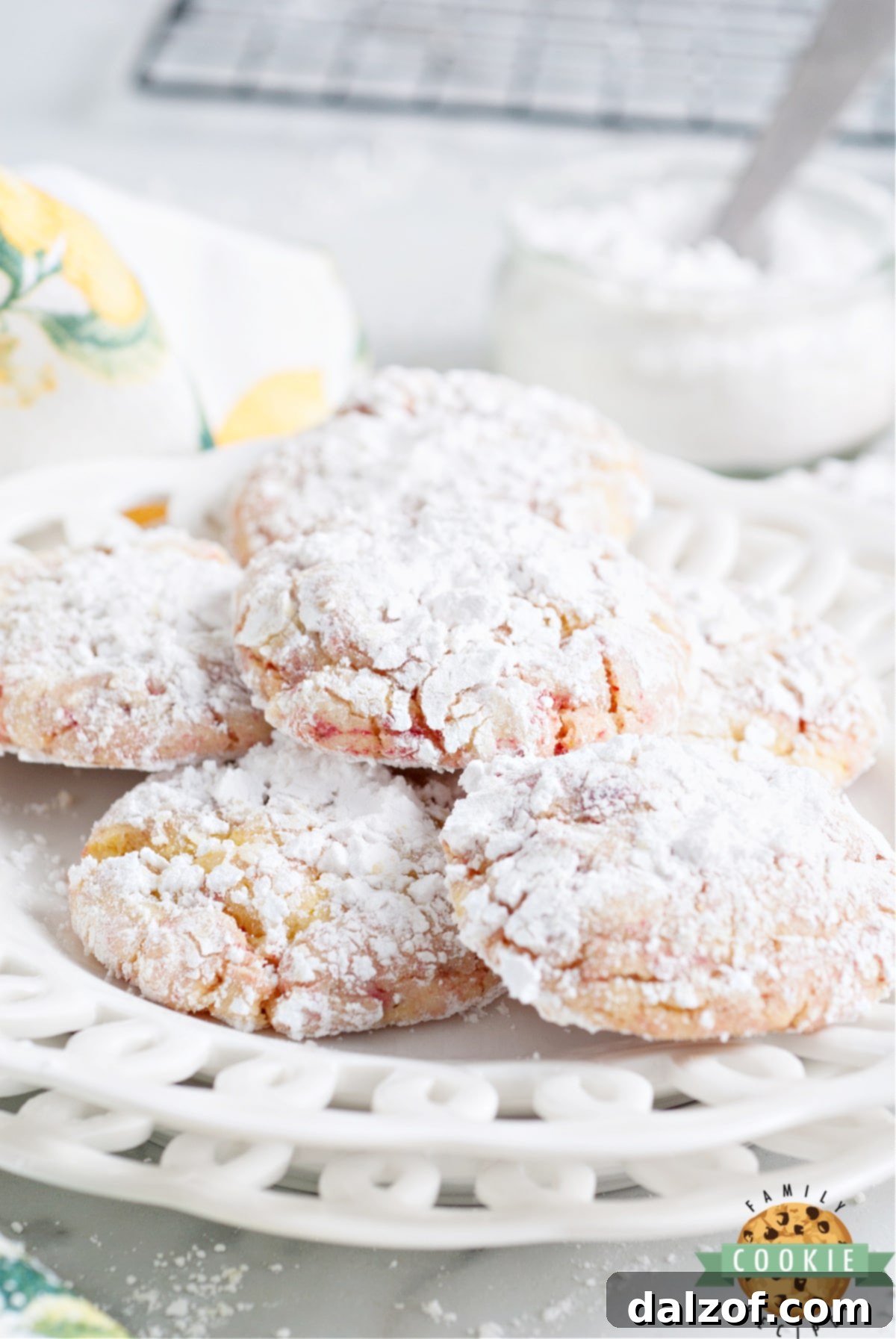 Close-up of a stack of Lemon Cake Mix Crinkle Cookies, showcasing the powdered sugar coating and soft texture.