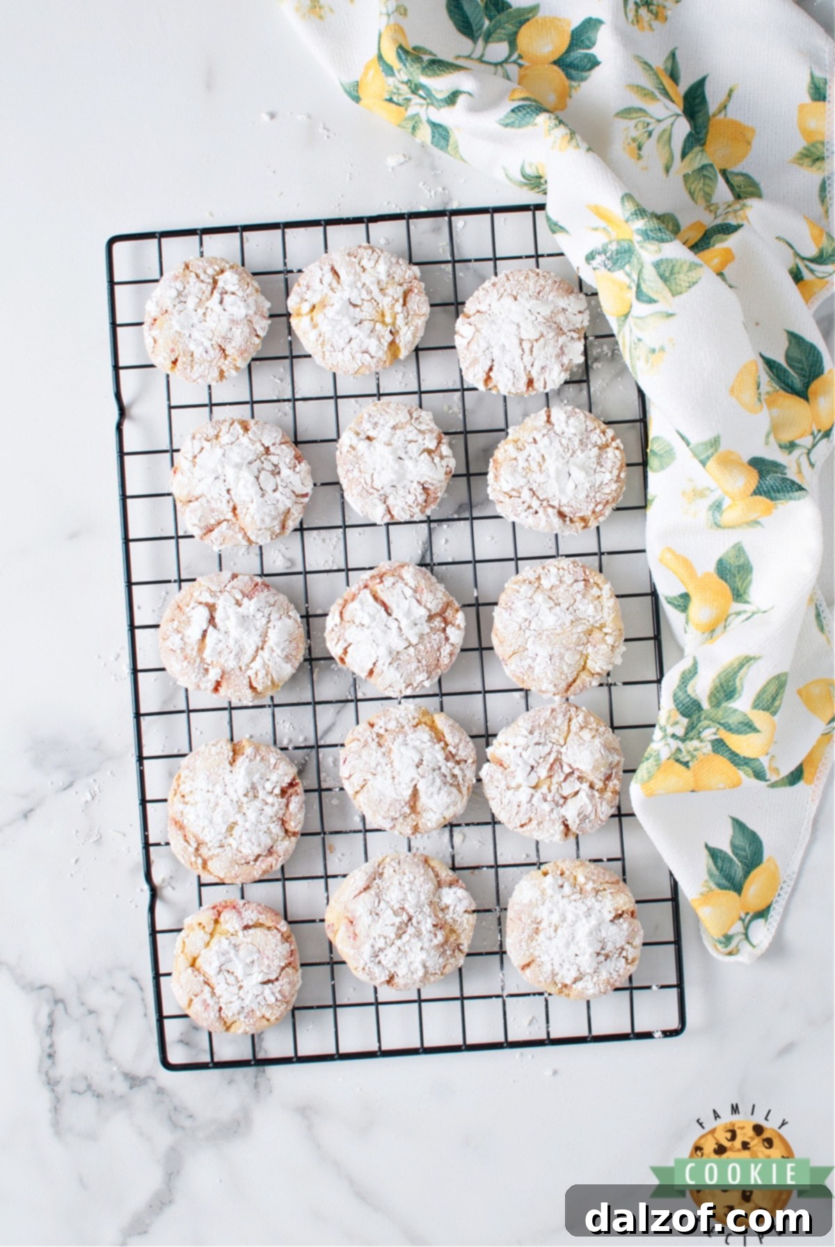 A beautifully composed shot of Lemon Cake Mix Crinkle Cookies on a white plate, highlighting their vibrant colors and powdery tops.