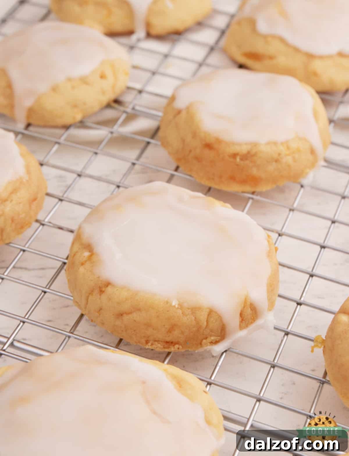 Close-up of Glazed Mandarin Orange Cookies, showing the vibrant orange glaze and soft texture.