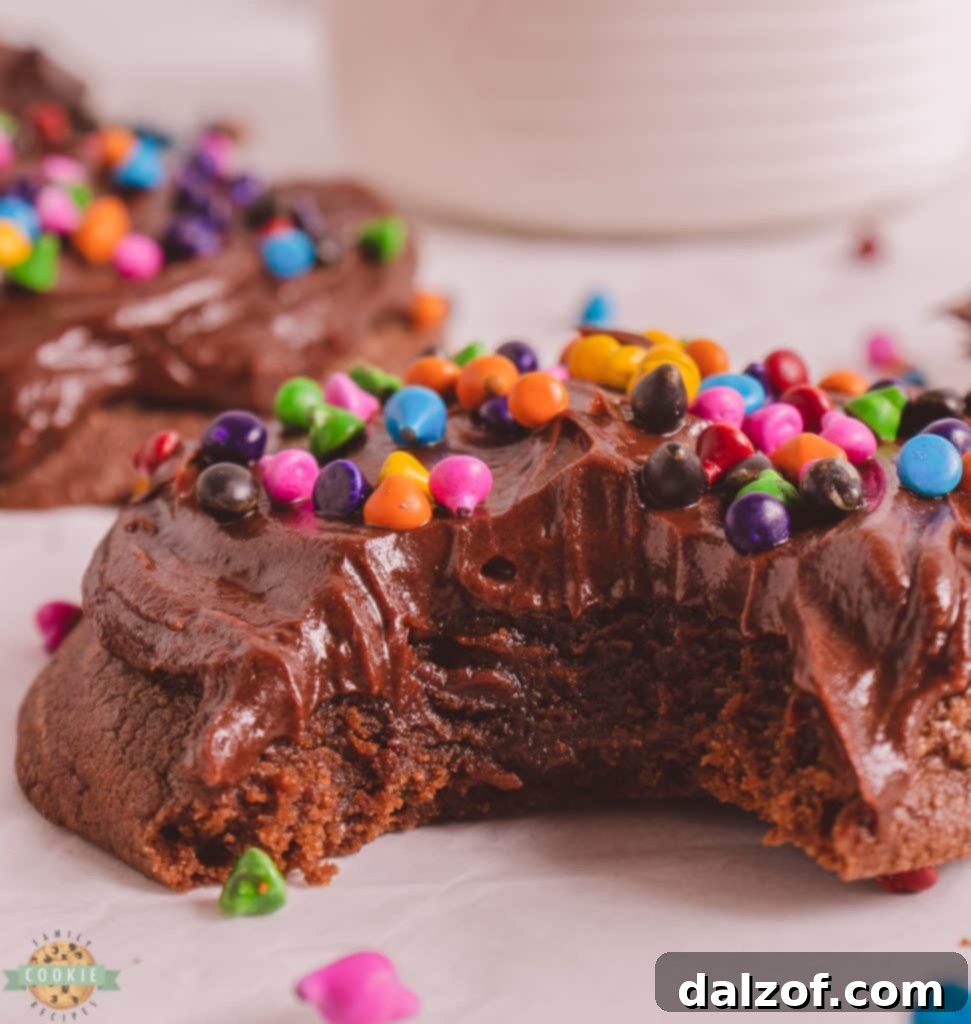 Close-up of a bite of a cosmic brownie cookie, showing its soft interior