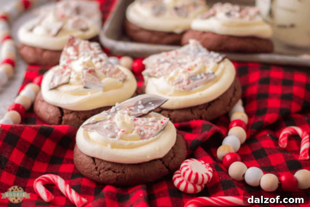 Close-up of a decorated Peppermint Bark Cookie, showing the chocolate base, white frosting, and crushed peppermint topping.