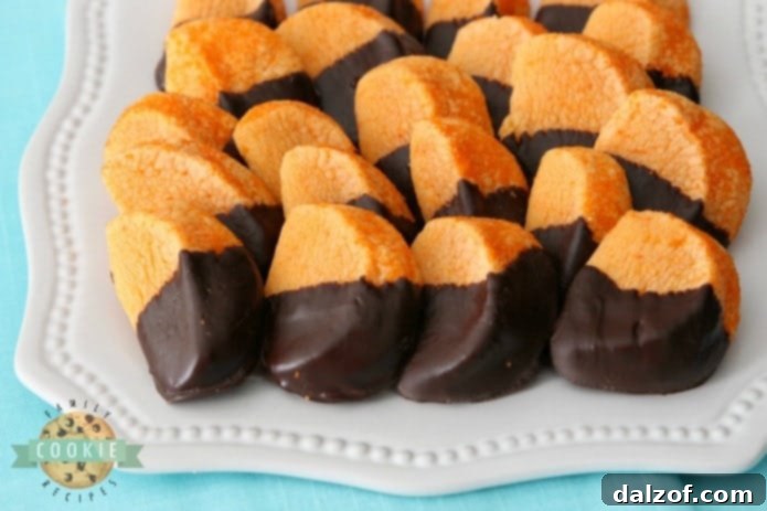 Chocolate Orange Slice Cookies mimic orange slices dipped in chocolate. Bright, tangy citrusy flavor comes from orange Kool-Aid mix baked into the cookies! Perfect cookie recipe for cookie exchanges and during the holidays.