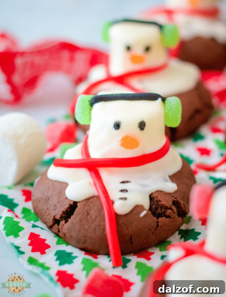 Adorable Peppermint Snowman Cookies, intricately decorated with chocolate and candy elements.