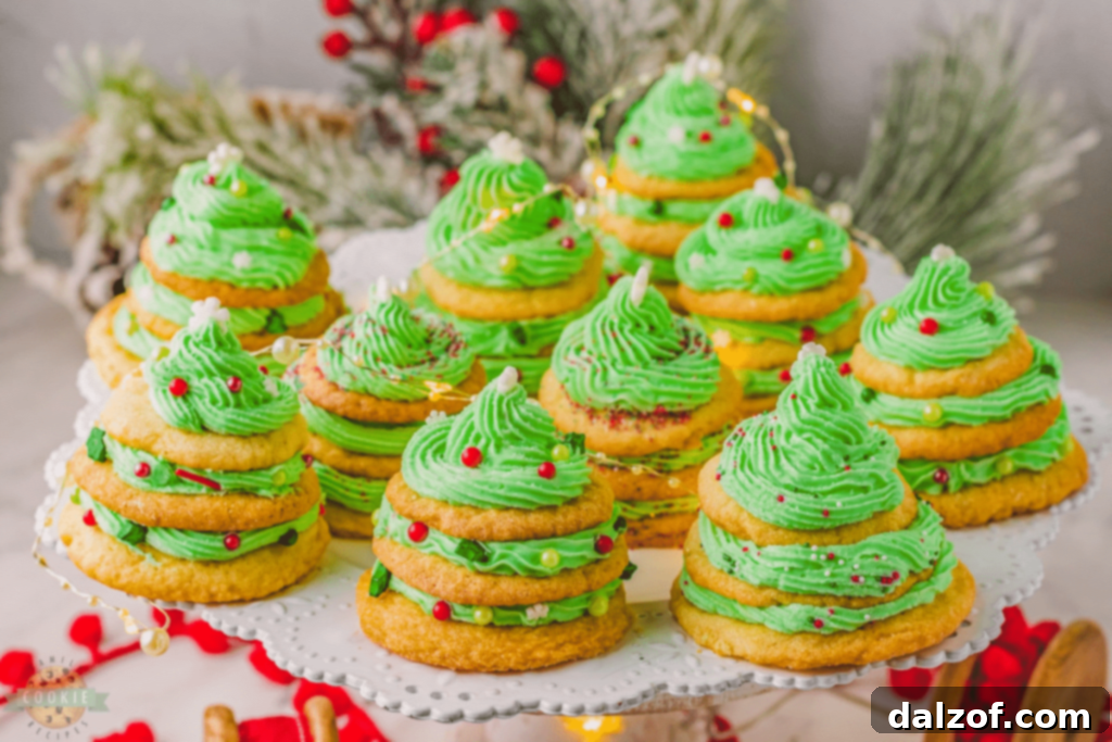 Creative Stacked Christmas Tree Cookies, featuring layers of green frosting and sprinkles.