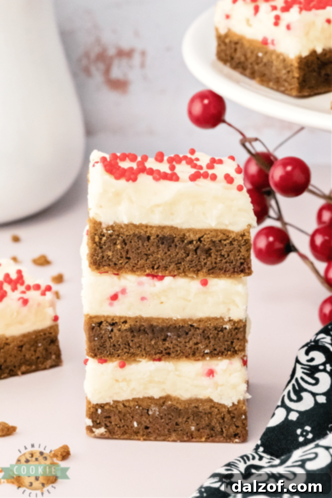 Thick and soft Gingerbread Cookie Bars with a creamy cream cheese frosting, perfect for the holiday season.