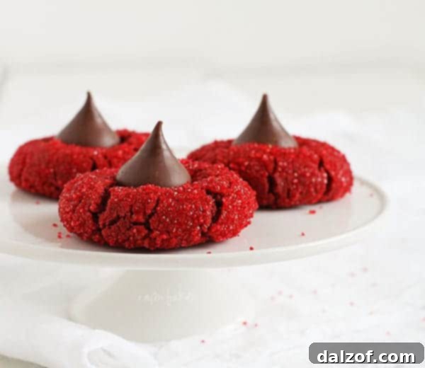 Red Velvet Peanut Butter Blossoms, a twist on the classic with extra cocoa richness and red sanding sugar.