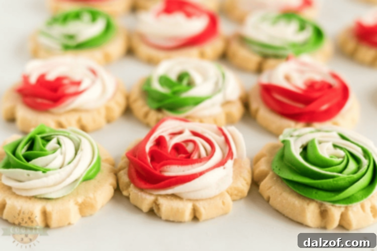 Elegant Frosted Rose Sugar Cookies, shaped like roses with intricate frosting swirls.