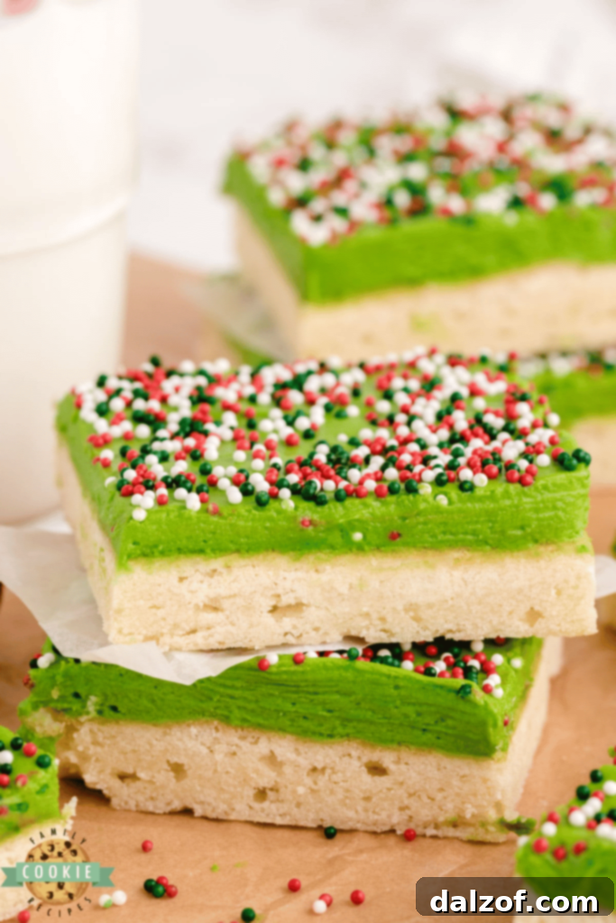 Thick, soft, and amazing Christmas Sugar Cookie Bars, topped with festive icing.