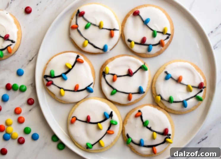 Christmas Lights Cookies with royal icing and mini M&Ms as lights, a charming holiday treat.
