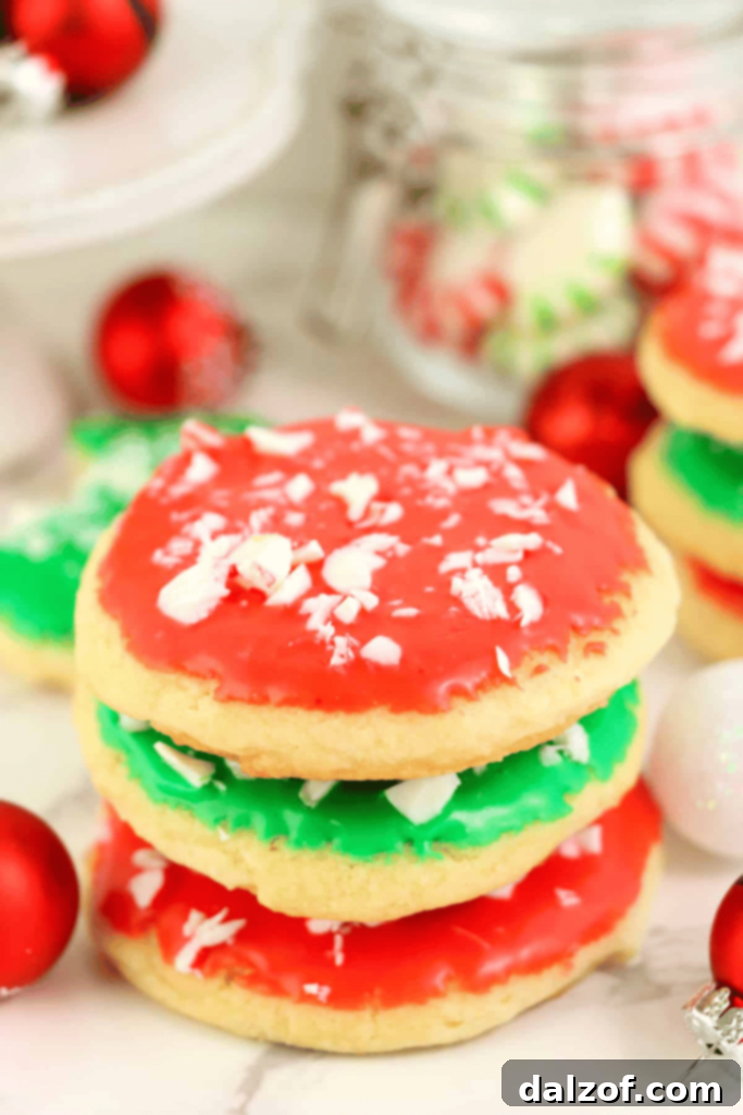 Soft and light Christmas Sugar Cookies, dipped in vibrant frosting and topped with crushed mints.