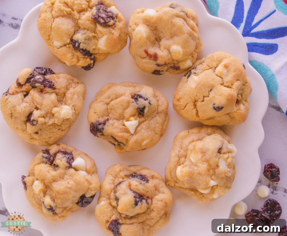A plate brimming with freshly baked, chewy white chocolate cherry cookies, ready to be enjoyed.