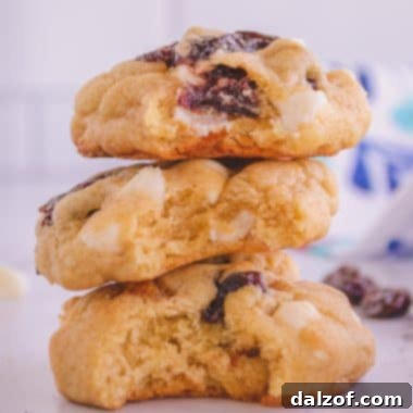A close-up of white chocolate cherry cookies in a stack, emphasizing their appealing texture and color.