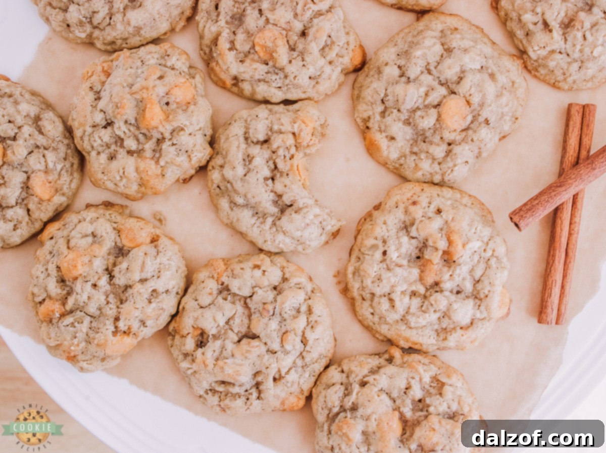 Freshly baked oatmeal scotchies cooling on parchment paper on a baking sheet