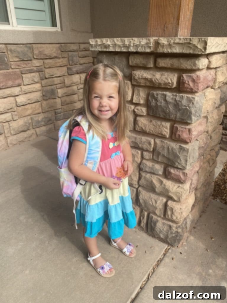 A young child, likely the author's youngest, on her first day of preschool.