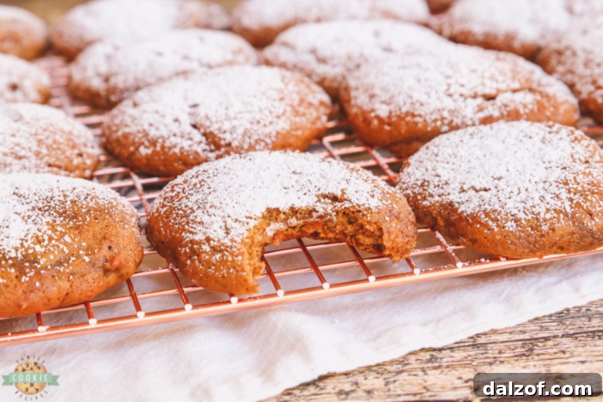 Banana molasses cookies cooling on a copper rack