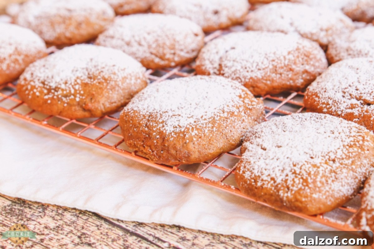 Freshly baked banana molasses cookies on a copper cooling rack