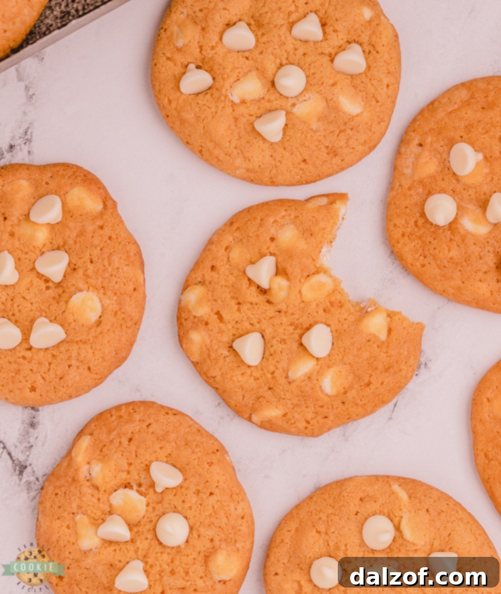 soft butterscotch pudding cookie with a bite taken out, revealing white chocolate chips