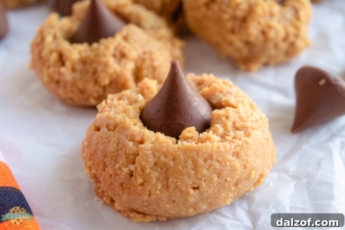 A perfectly formed no-bake peanut butter cookie topped with a chocolate kiss, ready to be enjoyed.