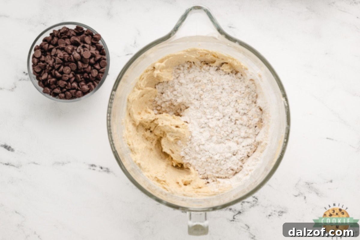 Combining wet and dry ingredients to form cookie dough.