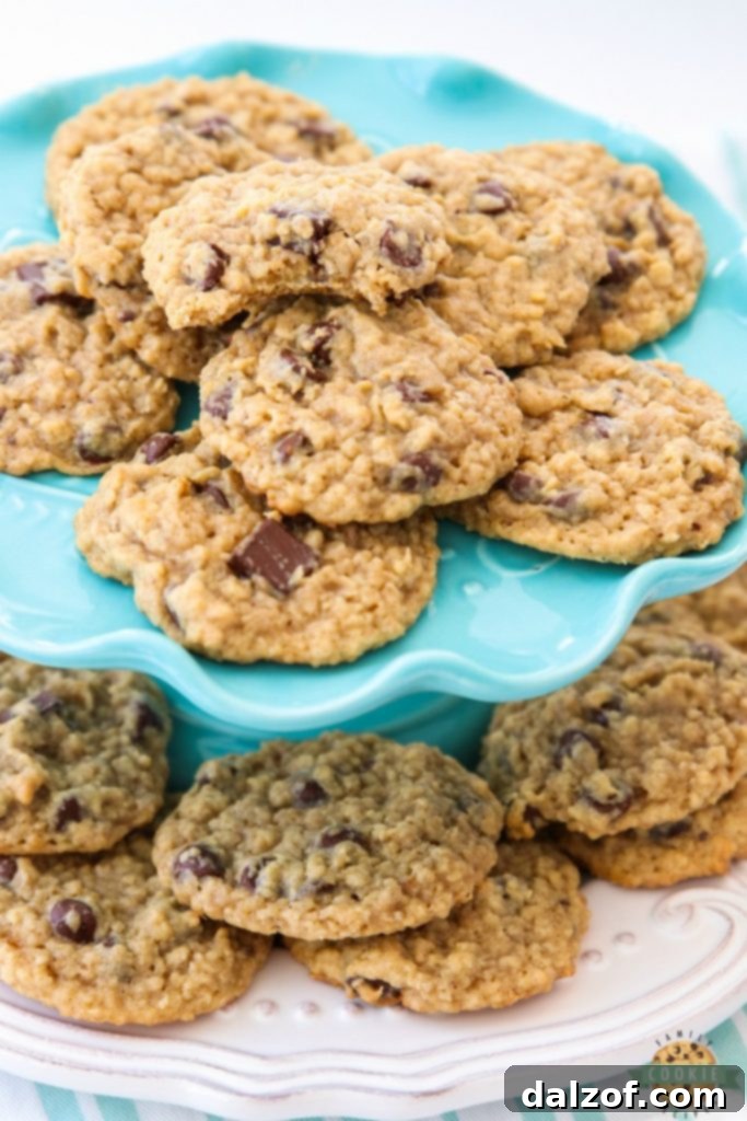 Delicious Chocolate Chip Oatmeal Cookies stacked high, showcasing their soft, chewy texture and abundant chocolate chips – a perfect homemade cookie recipe.