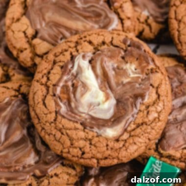 A stack of Andes Mint Chocolate Cookies with a melted mint frosting