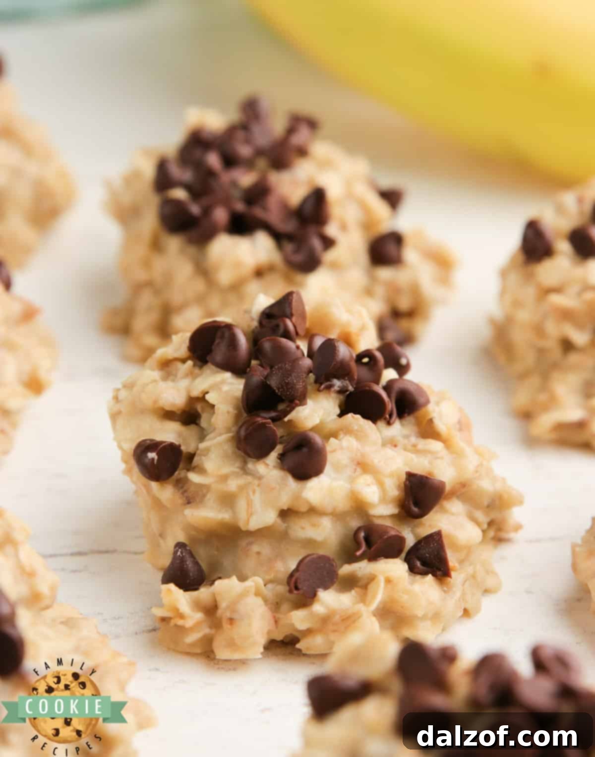 A stack of perfectly formed banana no-bake cookies on a rustic wooden surface.
