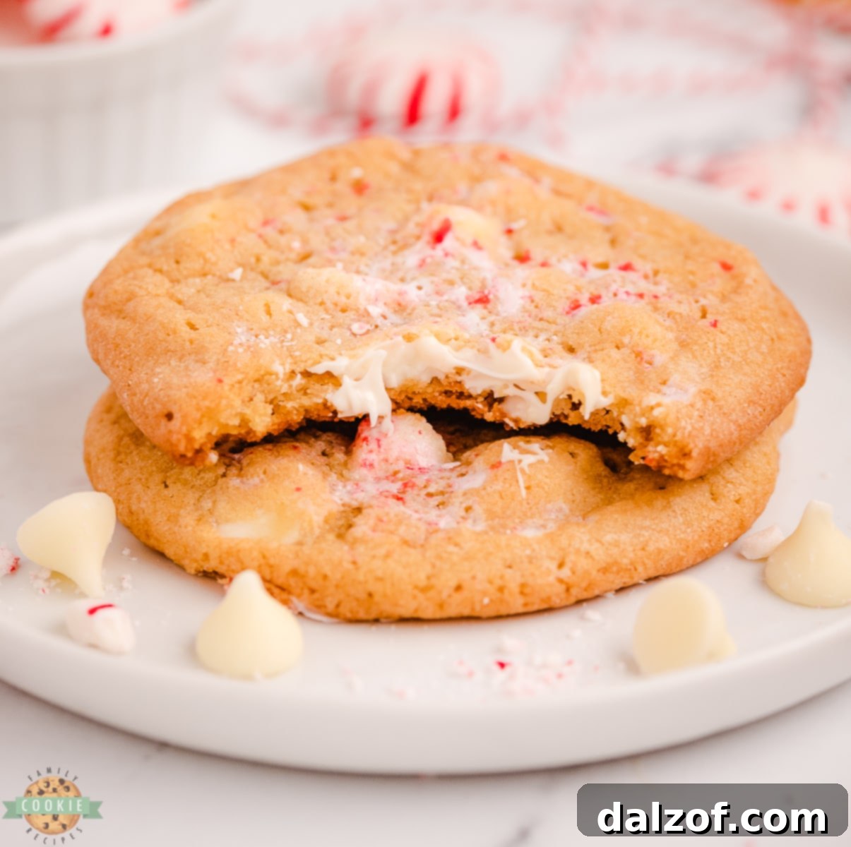 Close-up of freshly baked white chocolate peppermint cookies, perfectly golden with visible white chocolate chips and crushed peppermint pieces