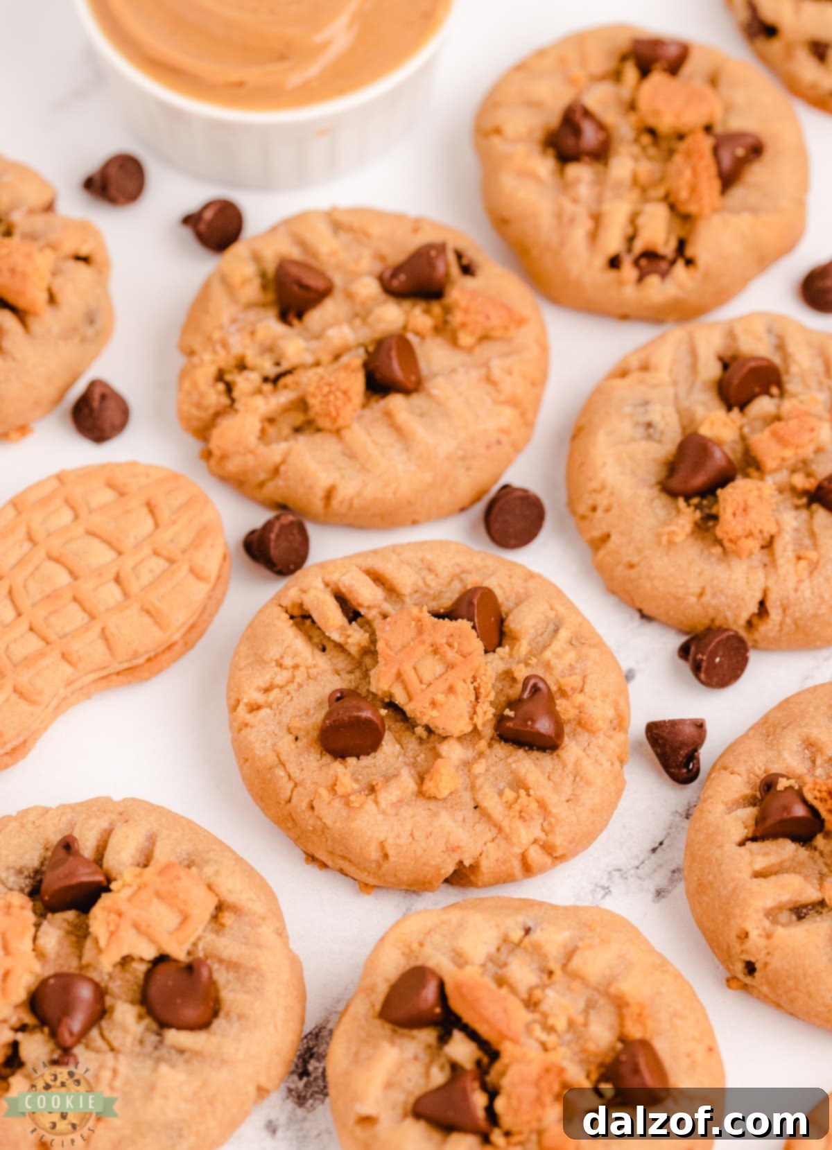 Close-up of freshly baked chocolate chip cookies with visible Nutter Butters baked right into them, highlighting their unique texture.