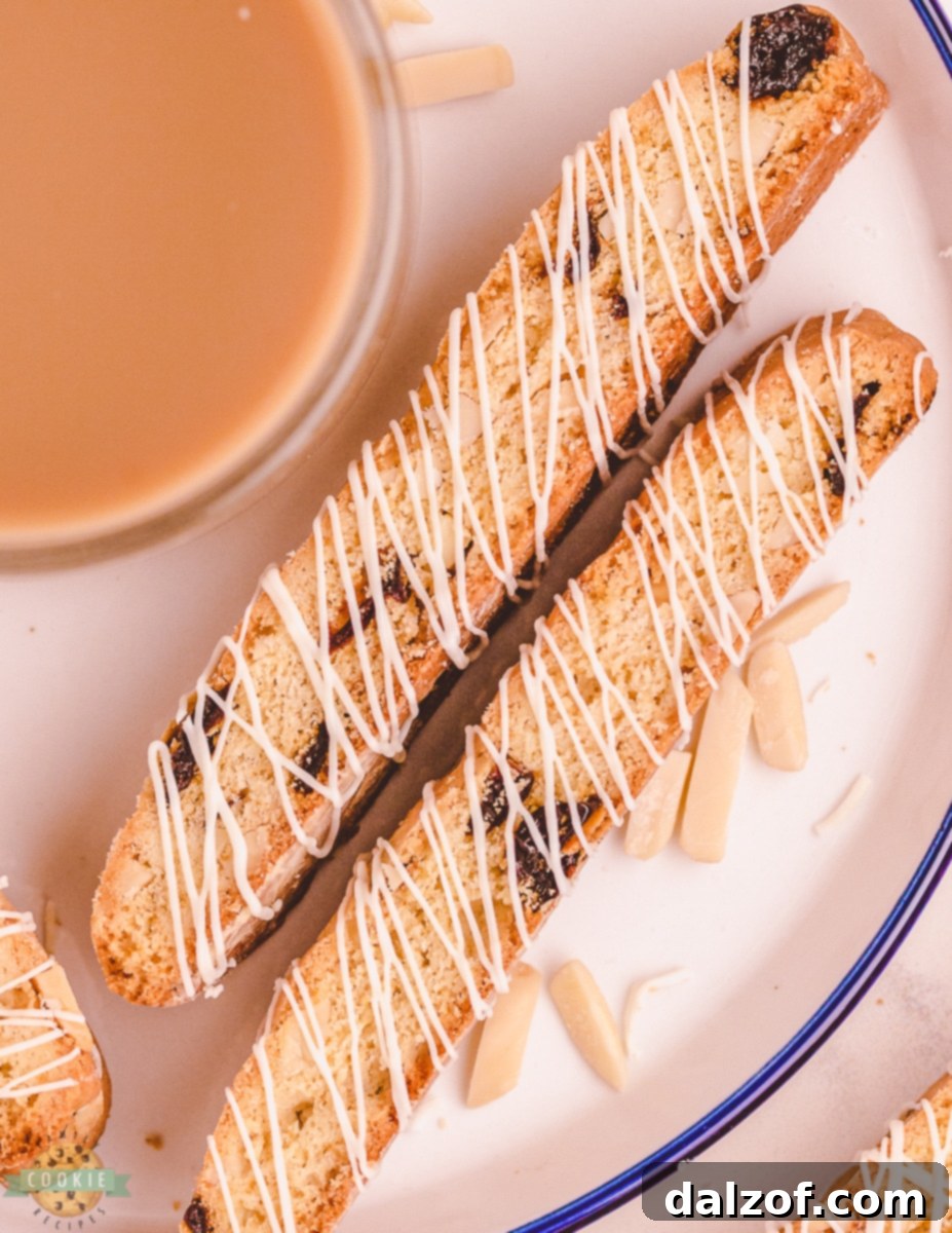 Cherry biscotti served on a plate with coffee in the background