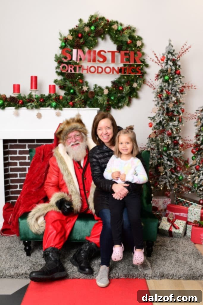 A heartwarming image of a child and an adult on Santa's lap during the holidays.