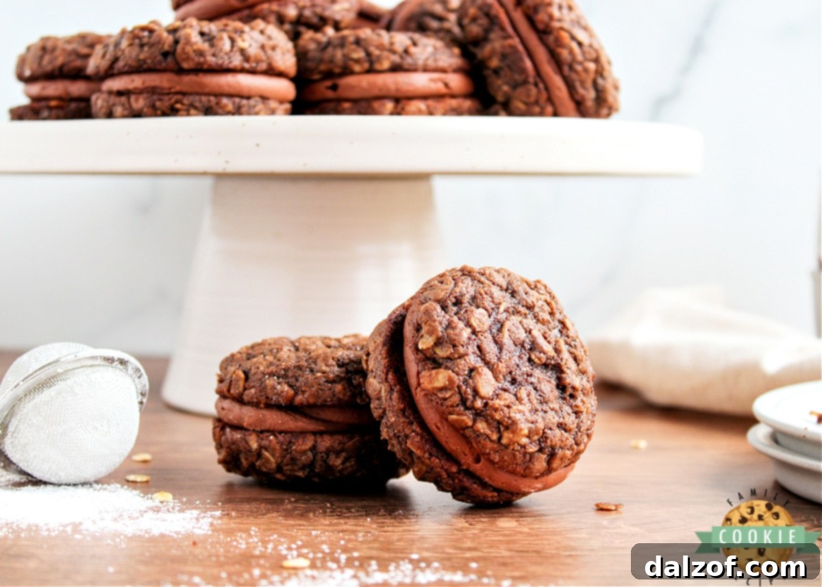 Decadent Chocolate Oatmeal Cream Pies 12 Close-up of a stack of chocolate oatmeal cookie sandwiches with creamy chocolate frosting.
