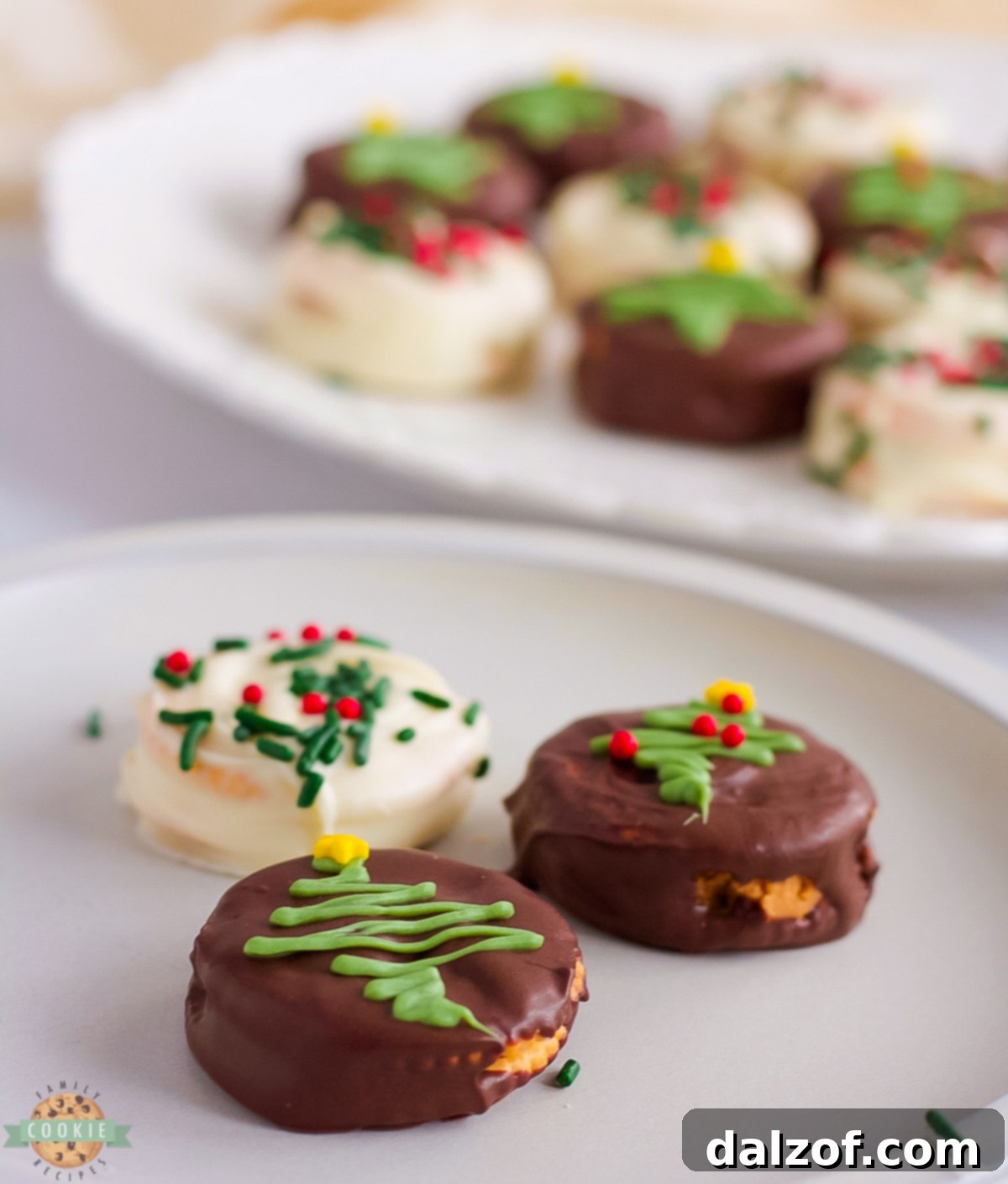 Homemade Ritz cookies with chocolate and peanut butter on a white plate