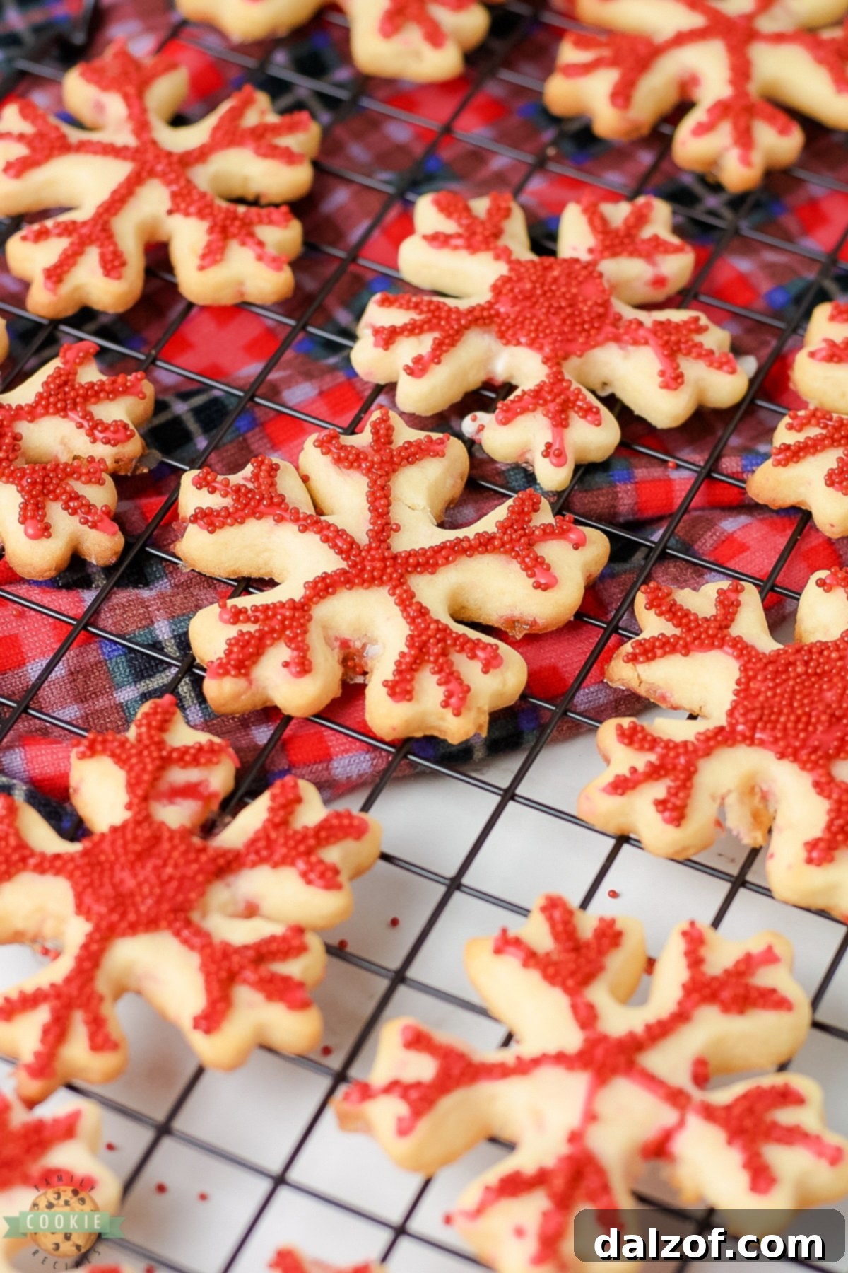 Freshly baked peppermint snowflake cookies cooling on a wire rack