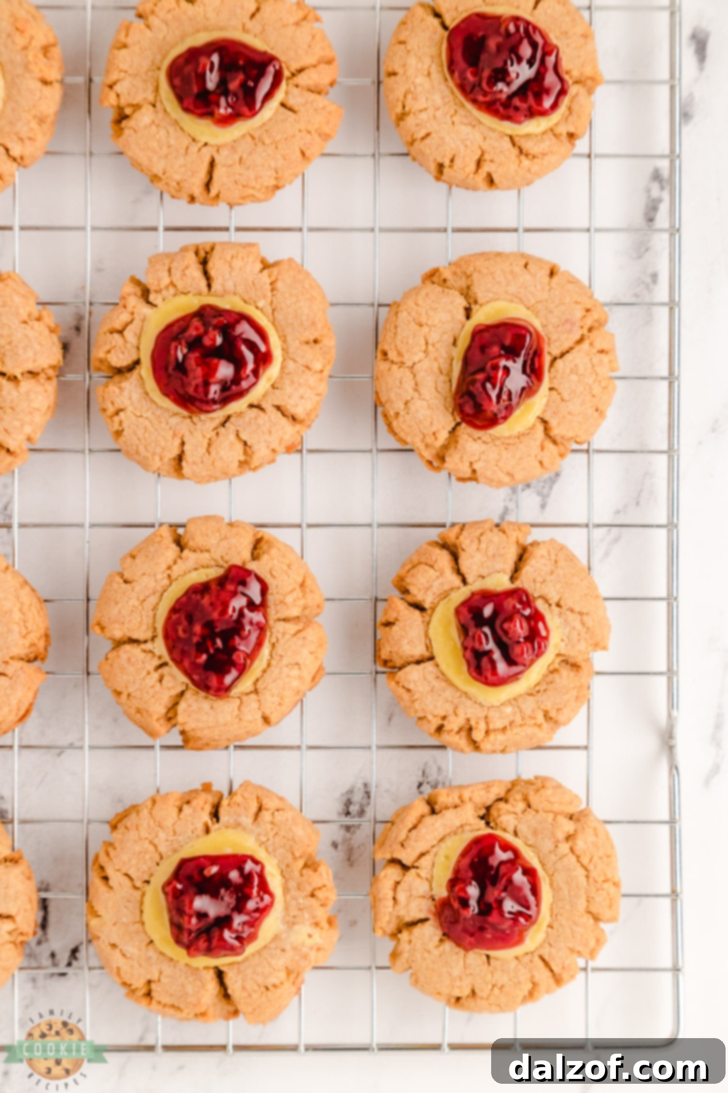 Freshly baked raspberry cheesecake cookies arranged on a wire cooling rack, allowing them to set perfectly.