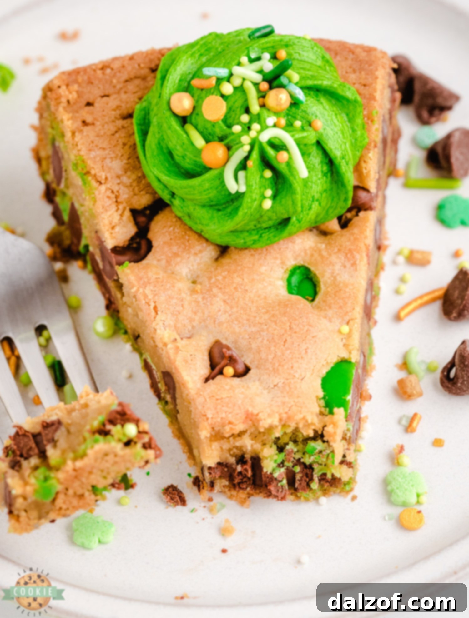 A generous slice of green cookie cake ready to be enjoyed