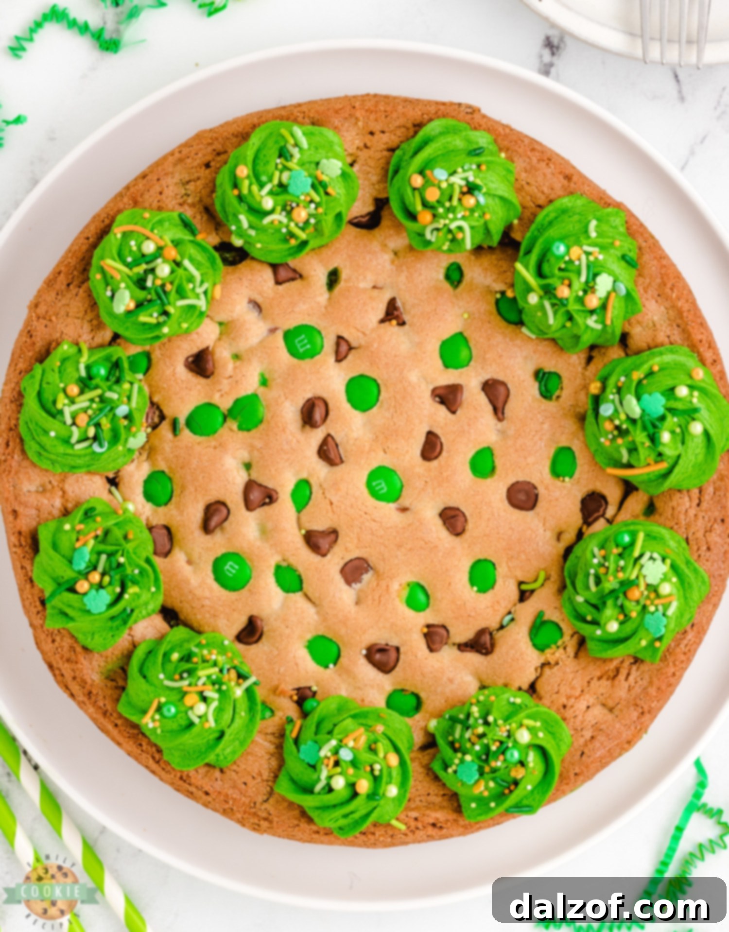 A whole festive St. Patrick's Day cookie cake with green frosting and sprinkles